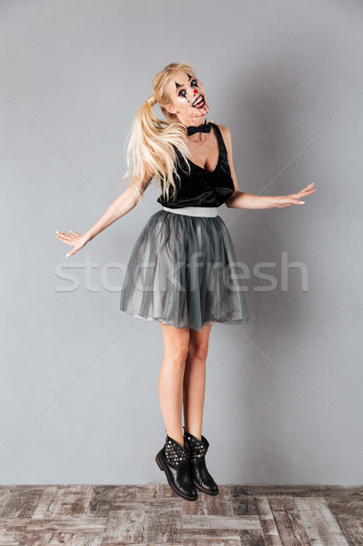 Full length portrait of a smiling crazy blonde woman Stock photo © deandrobot