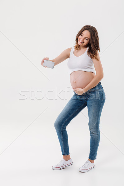 Happy pregnant woman make selfie with her belly Stock photo © deandrobot