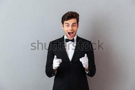 Young successful business man talking on mobile phone while hold Stock photo © deandrobot