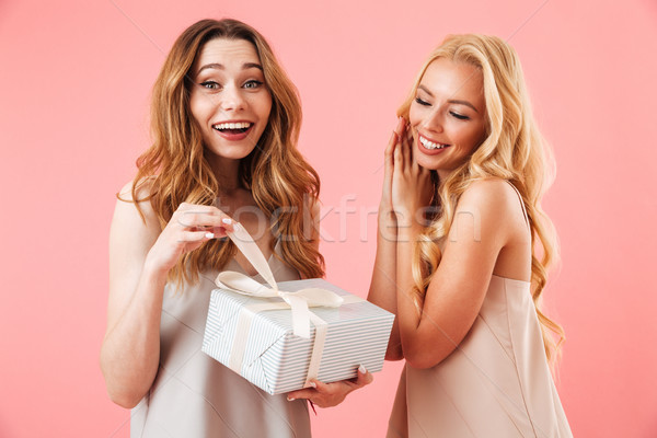 Surprised happy brunette woman in pajamas standing with her friend Stock photo © deandrobot