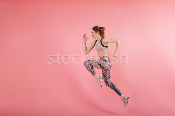 Serious concentrated young fitness sports woman Stock photo © deandrobot