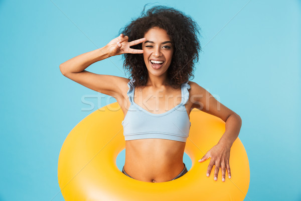 Portrait of a happy african girl dressed in swimsuit Stock photo © deandrobot