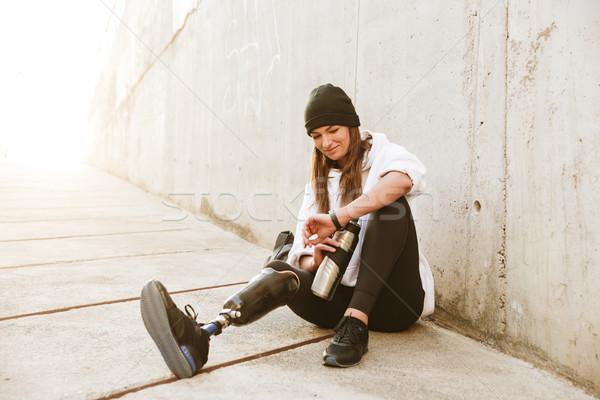 Photo of content handicapped woman having bionic leg in streetwe Stock photo © deandrobot
