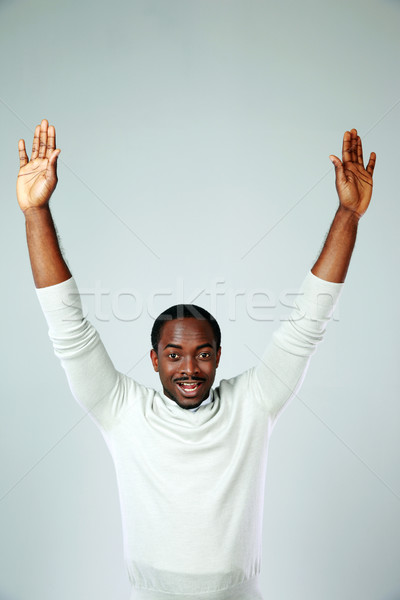 Retrato africano homem as mãos levantadas cinza mãos Foto stock © deandrobot