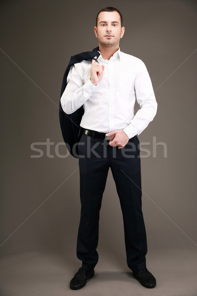Full length portrait of a businessman holding his jacket over shoulder Stock photo © deandrobot