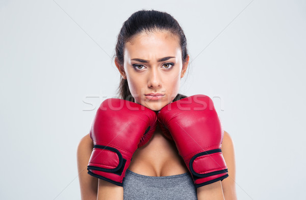 Sports woman standing in defence stance with boxing gloves Stock photo © deandrobot
