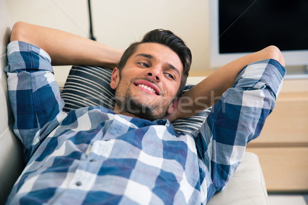 Sonriendo hombre sofá retrato casa Foto stock © deandrobot