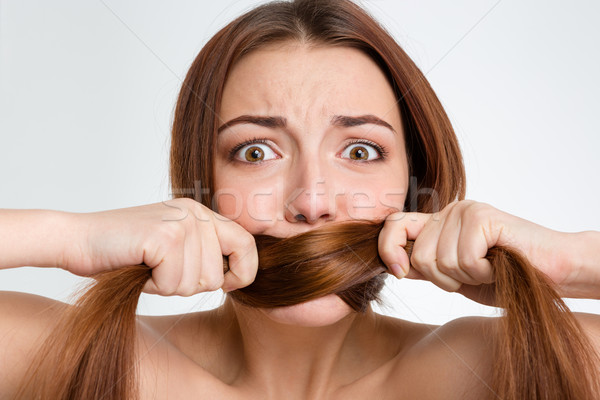 Scared frightened young woman covered mouth with her long hair  Stock photo © deandrobot