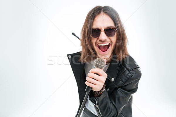 [[stock_photo]]: Heureux · jeune · homme · cheveux · longs · micro · chanter · lunettes · de · soleil