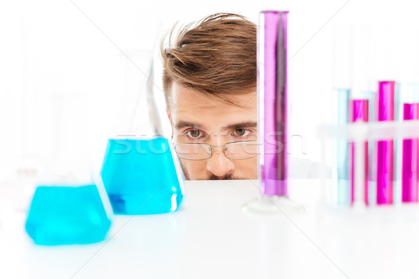Chemist is analyzing sample Stock photo © deandrobot