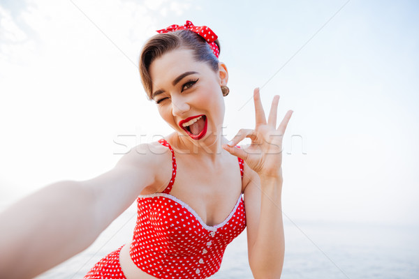 Boldog csinos pinup lány piros fürdőruha Stock fotó © deandrobot