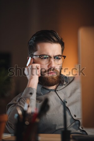 Young web designer working late at night Stock photo © deandrobot