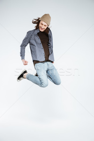 Függőleges kép boldog hipszter ugrik stúdió Stock fotó © deandrobot