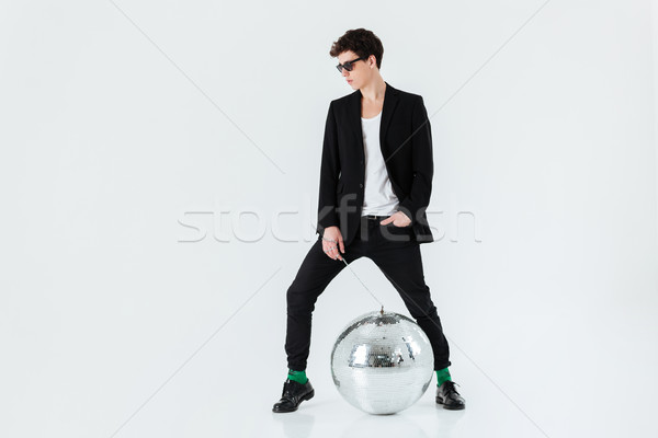Full length portrait of man in suit with disco ball Stock photo © deandrobot