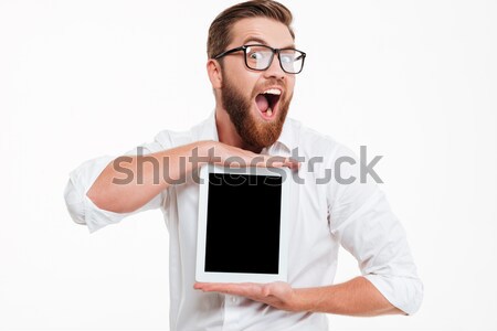 Happy man showing blank tablet computer screen at camera Stock photo © deandrobot