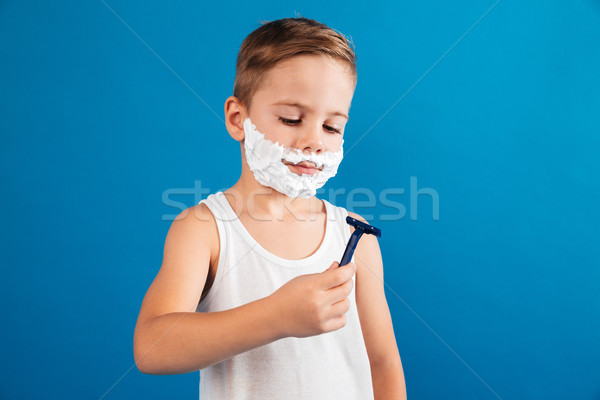 Picture of Smiling young boy in shaving foam like man Stock photo © deandrobot