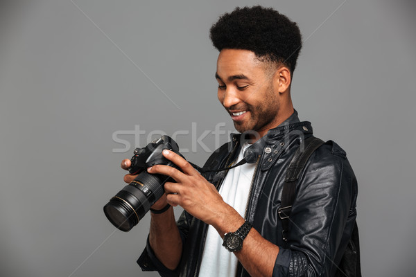 Close-up portrait of young happy afro american man holding and l Stock photo © deandrobot