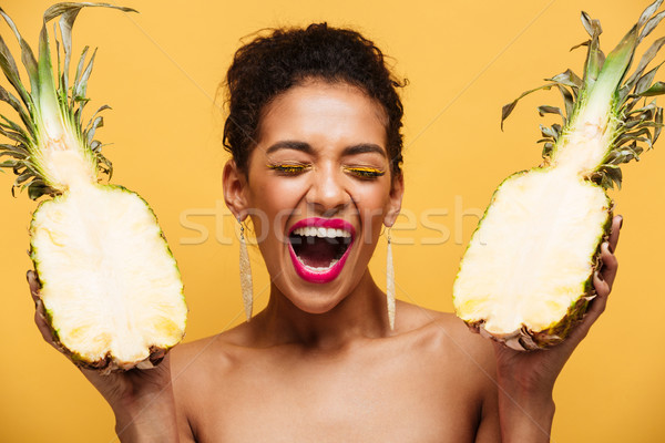 Happy adult woman with afro hairstyle and trendy makeup holding  Stock photo © deandrobot