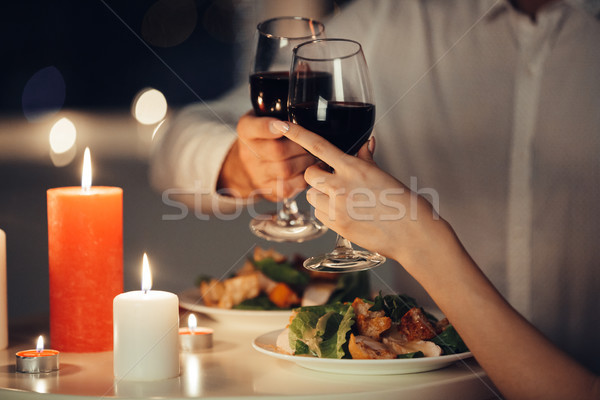 Cropped photo of lovers having romantic dinner at home Stock photo © deandrobot