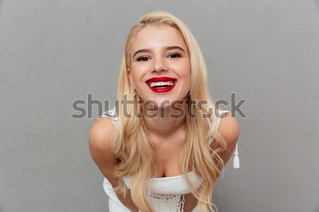 Portrait of a playful girl winking and looking at camera Stock photo © deandrobot