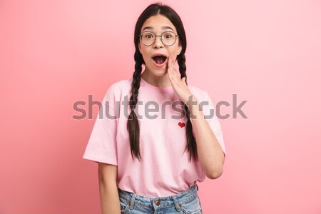 Portrait of a shocked pretty girl looking at camera Stock photo © deandrobot