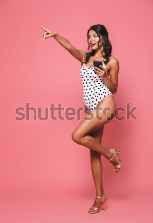 Full length portrait of a pretty seductive woman in swimsuit Stock photo © deandrobot