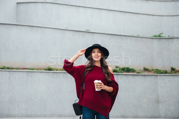 Stock photo: Portrait of a smiling asian girl dressed in hat