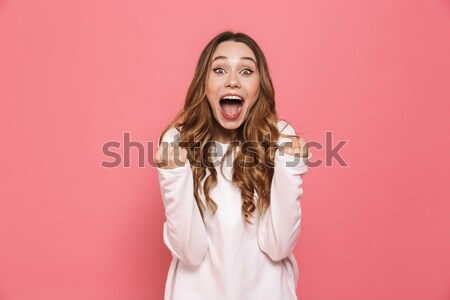 Stock photo: Happy young pretty woman make winner gesture.