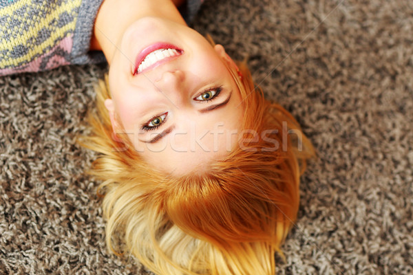 Portrait souriant jeune femme tapis maison [[stock_photo]] © deandrobot