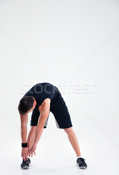 Athletic man doing warm up exercises Stock photo © deandrobot
