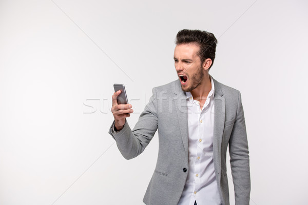 Businessman screaming on smartphone  Stock photo © deandrobot