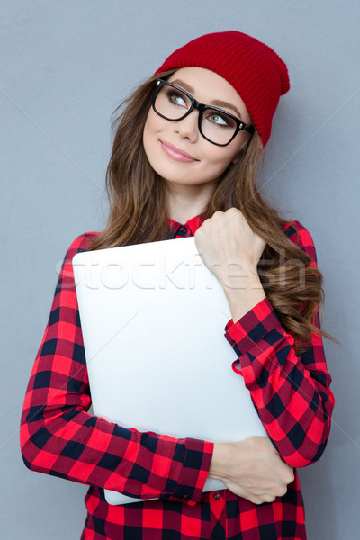 Stock photo: Woman holding laptop computer and dreaming