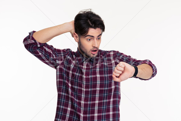 Shocked man looking on wrist watch Stock photo © deandrobot