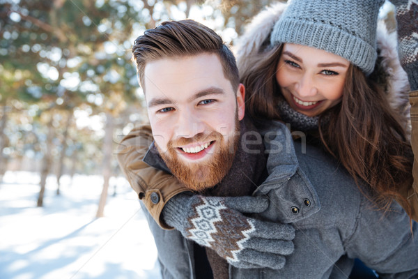 Smling couple walking in winter park Stock photo © deandrobot