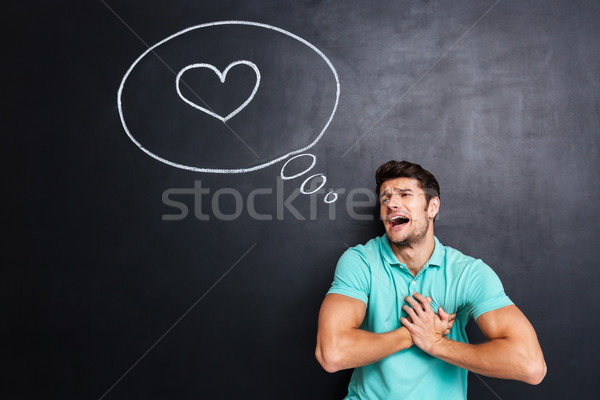 Unhappy embarrassed man crying and having heartache over chalkboard Stock photo © deandrobot