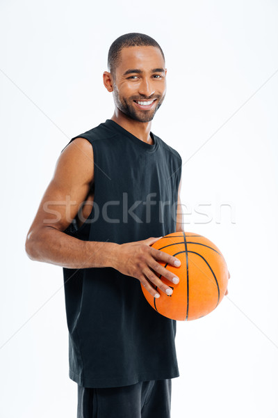 Laughing young cheerful african man with basket ball Stock photo © deandrobot