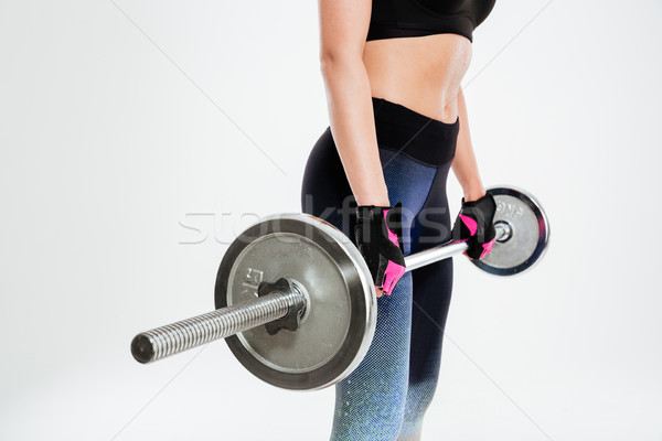 Cropped image of a young woman with barbell Stock photo © deandrobot