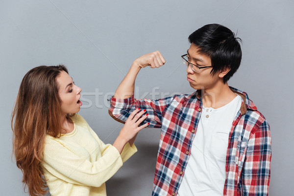 ázsiai fickó mutat bicepsz barátnő izolált Stock fotó © deandrobot