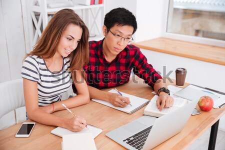 Students working for project in classroom with laptop and tablet Stock photo © deandrobot