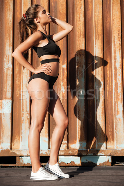 Relaxed young woman in black swimsuit standing with eyes closed Stock photo © deandrobot