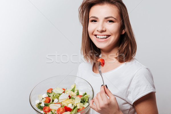 Ridere giovani signora mangiare insalata foto Foto d'archivio © deandrobot