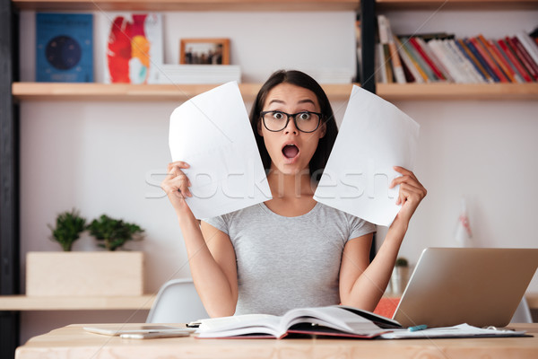 Shocked woman indoors working with documents. Stock photo © deandrobot