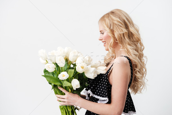 Side view of blonde woman posing with bouquet flowers Stock photo © deandrobot