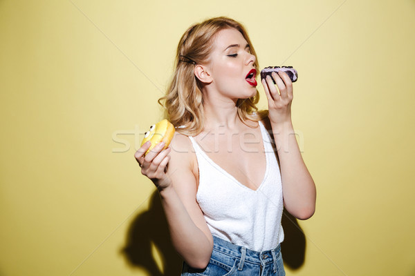 Woman with bright lips makeup eating sweeties. Stock photo © deandrobot