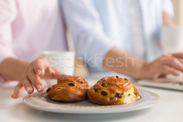 Cropped photo of mature loving couple family eating pastries. Stock photo © deandrobot