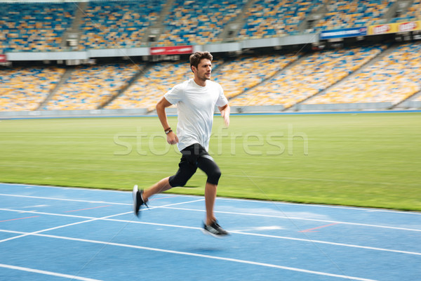 Stock photo: Side view of a young professional sprinter running