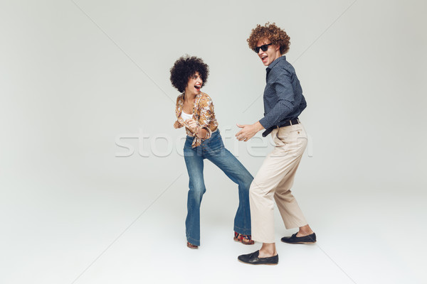 Happy retro loving couple dancing. Stock photo © deandrobot