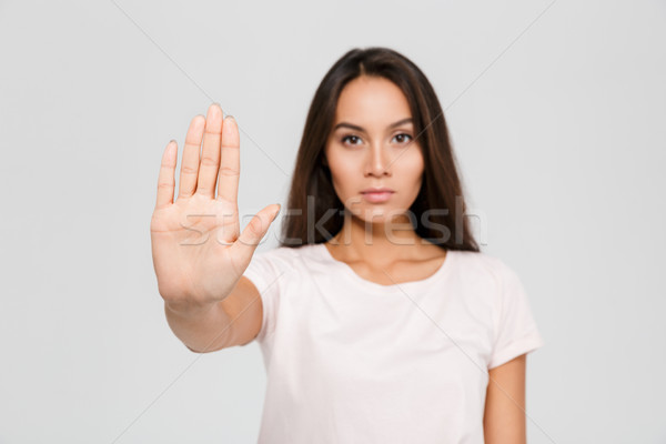 Stock photo: Portrait of a serious young asian woman standing