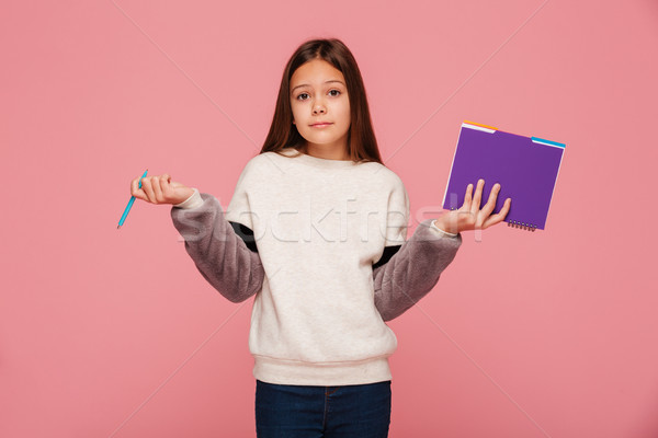 Calm serious girl looking camera and don't know what to do isolated Stock photo © deandrobot