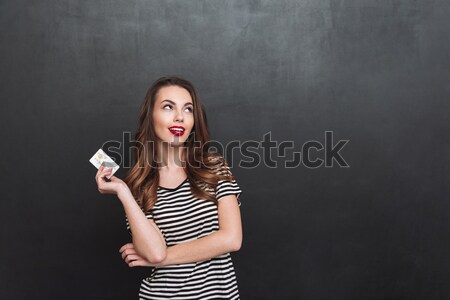 Surprised happy woman having idea putting index finger in air an Stock photo © deandrobot